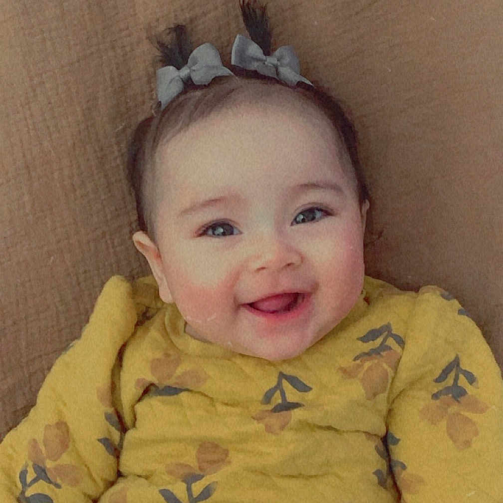 Alaina joined the competition — help win amazing prizes! accessories, baby, babylaughing, bodypart, clothing, coat, face, furniture, happy, head, jacket, laughing, mouth, pants, person, photography, portrait, sitting, smile, teeth