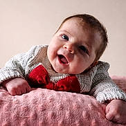 Flori joined the competition — help win amazing prizes! baby, smiling, happy, infant, blanket, knitted_sweater, red_bow, cute, portrait, child, soft_texture, pink, cozy, face, young_child, indoors, person, closeup, expression, cheerful