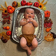 Beckett is registered to the contest to win money with this photo: baby, bed, diaper, face, flower, food, furniture, head, meal, newborn, person, petal, photography, plant, portrait, pottedplant, produce, pumpkin, squash, vegetable