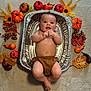 baby, bed, diaper, face, flower, food, furniture, head, meal, newborn, person, petal, photography, plant, portrait, pottedplant, produce, pumpkin, squash, vegetable