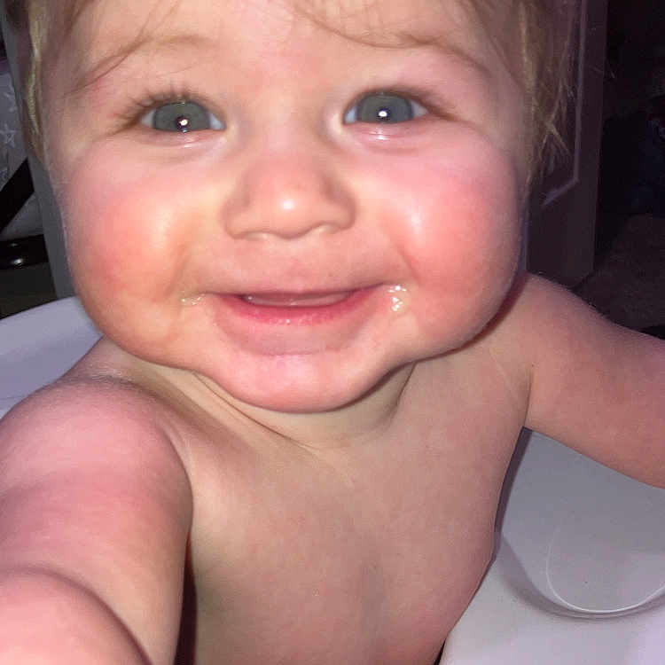 Liam is registered to the contest to win money with this photo: accessories, baby, babylaughing, bodypart, clothing, dress, face, finger, hand, happy, head, jewelry, laughing, mouth, necklace, person, photography, portrait, smile, teeth