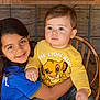 Lucca joined the competition — help win amazing prizes! child, toddler, hug, yellow_shirt, blue_shirt, lion_king, plush_toy, smiling, indoor, wooden_table, chair, cute, siblings, family, portrait, happy, candid, playful, cozy, floor