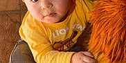 Lucca joined the competition — help win amazing prizes! brown_hair, carpet, child, curious, cute, eyes, face, floor_tiles, hand, indoor, lion_king, plush_toy, portrait, rolled_jeans, sitting, sneakers, soft_toy, toddler, toy, yellow_shirt