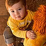 brown_hair, carpet, child, curious, cute, eyes, face, floor_tiles, hand, indoor, lion_king, plush_toy, portrait, rolled_jeans, sitting, sneakers, soft_toy, toddler, toy, yellow_shirt