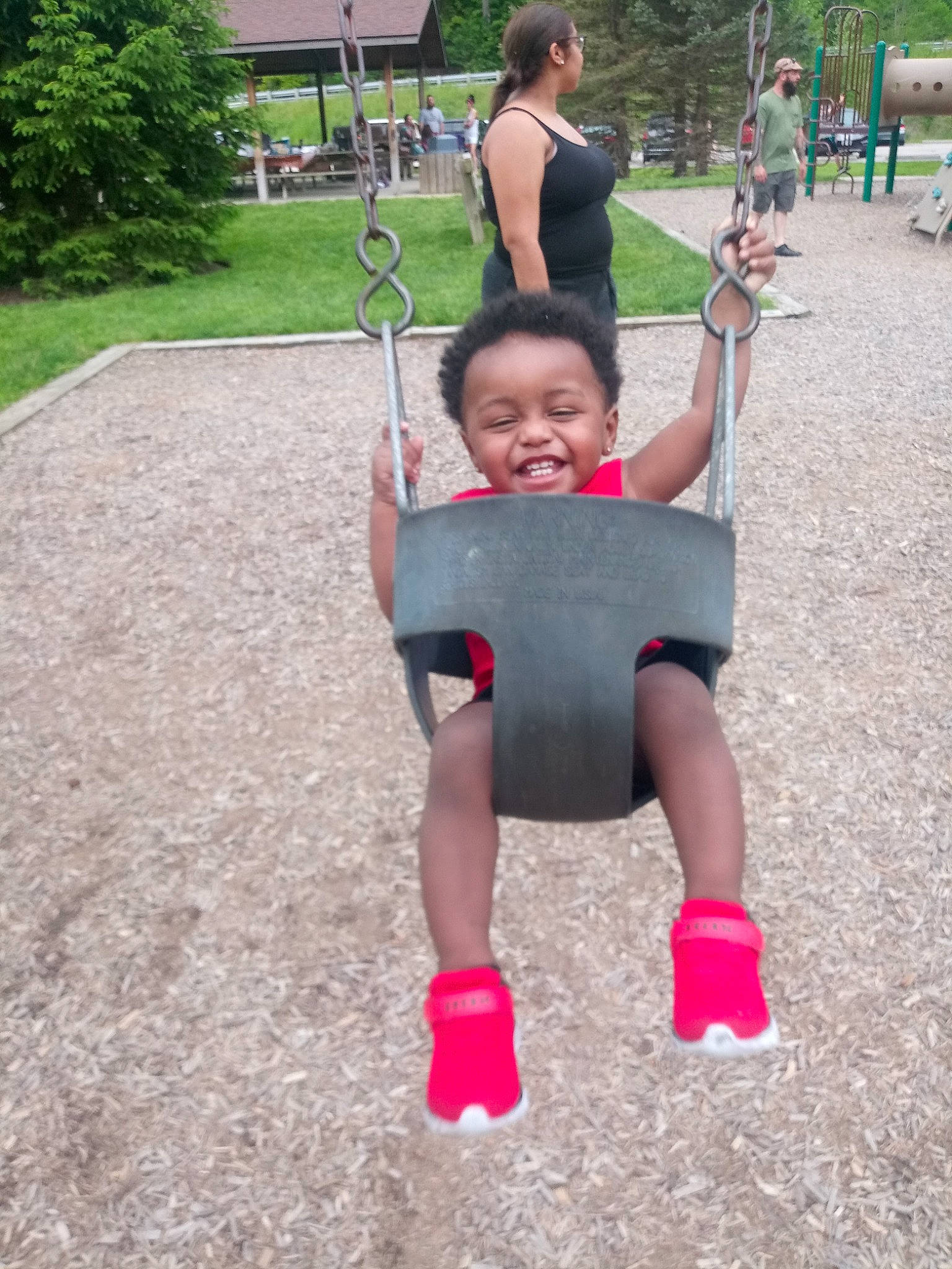 Jermaine Jr is registered to the contest to win money with this photo: child, city, fun, joy, leisure, outdoor_play_equipment, park, person, pink, play, playground, public_space, recreation, smile, style, summer, swing, toddler, vacation