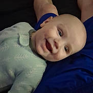 Jaxon is registered to the contest to win money with this photo: baby, smiling, child, onesie, person, legs, blue_shorts, indoor, happy, face, skin, patterned_clothing, infant, casual, comfortable, portrait, lying_down, closeup, human, baby_clothes