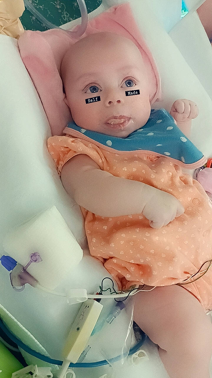 Elana is registered to the contest to win money with this photo: abdomen, baby_products, bathing, cheek, chest, child, eyebrow, eyelash, human_leg, joint, mouth, nail, peach, person, pink, skin, thigh, thumb, toddler, toy