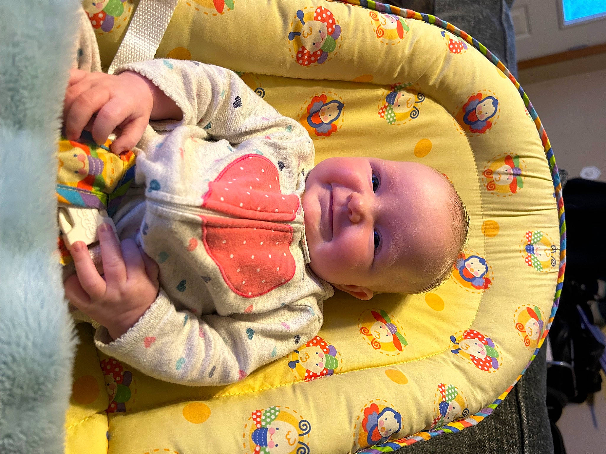 Lila is registered to the contest to win money with this photo: baby, baby_products, baby_toddler_clothing, baby_toys, cheek, child, comfort, event, eye, fun, happy, mouth, pattern, person, play, room, sitting, skin, smile, toddler