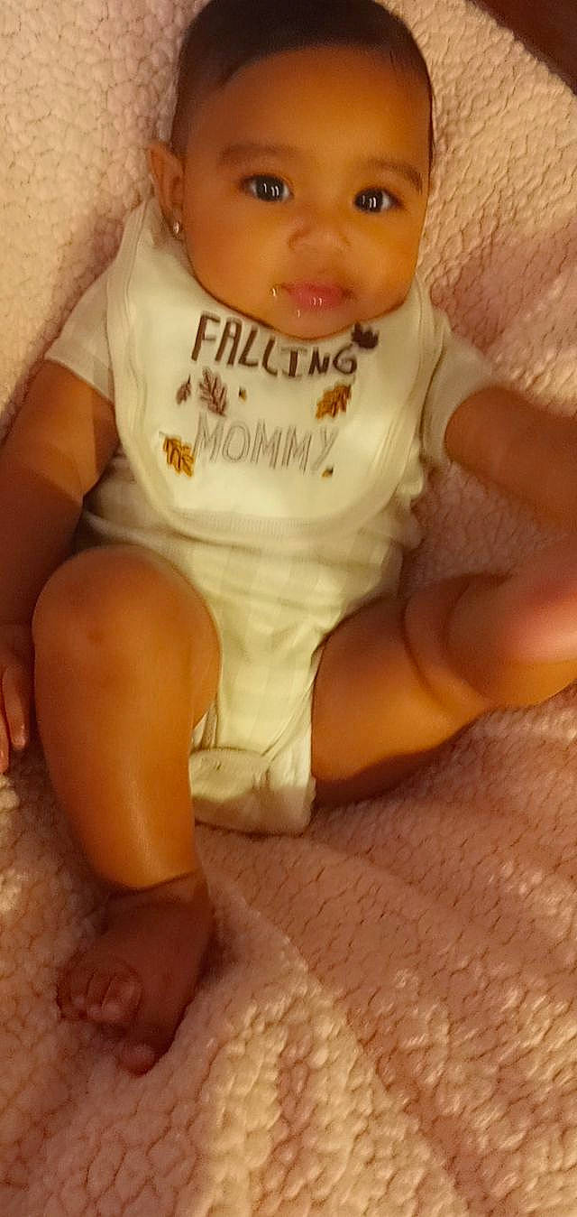 Arielle is registered to the contest to win money with this photo: arm, baby_toddler_clothing, cheek, chest, finger, flooring, hand, happy, human_body, joint, lip, mouth, neck, nose, person, pink, skin, sleeve, thigh, toddler