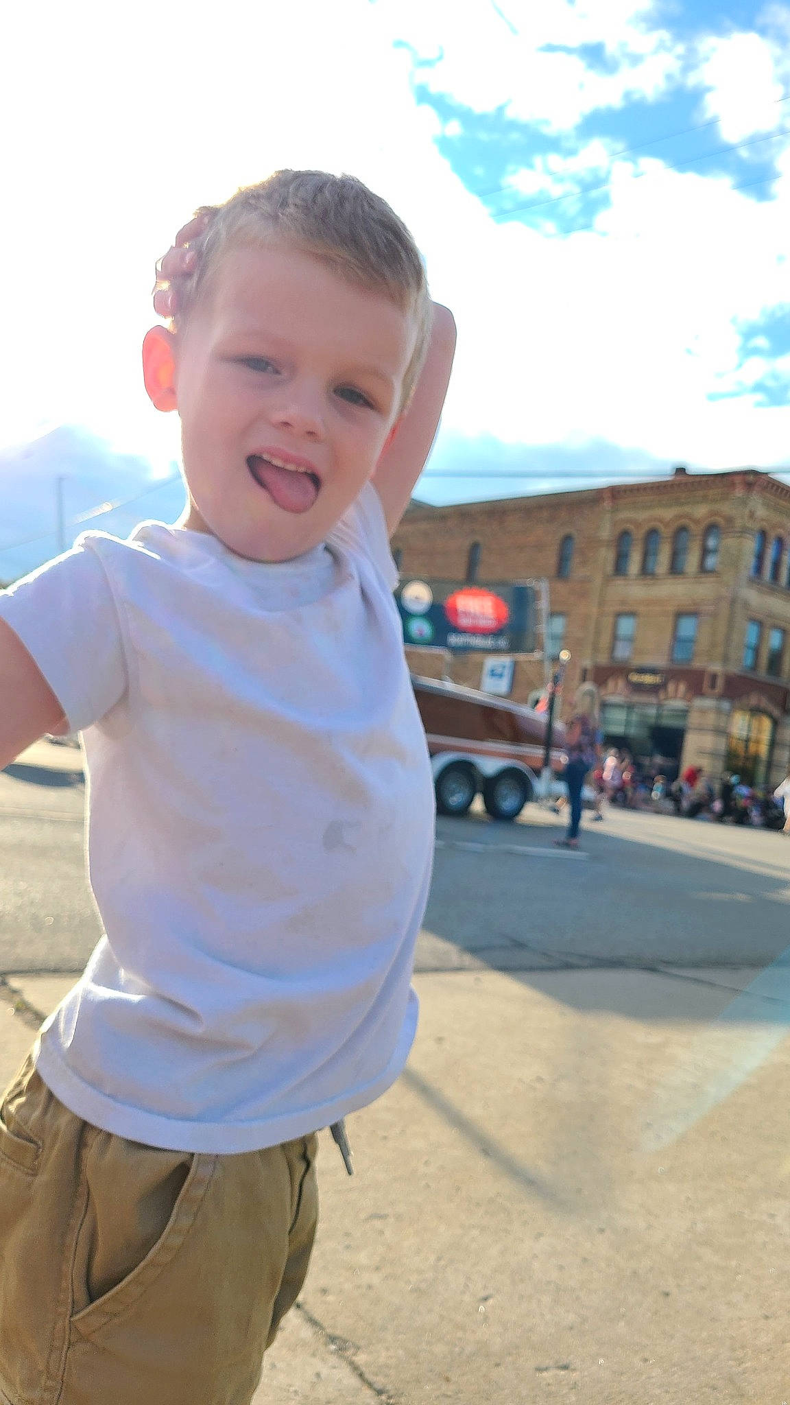Colton is registered to the contest to win money with this photo: asphalt, baby, child, cloud, electric_blue, fun, gesture, happy, leisure, person, recreation, road, sky, sleeve, smile, t_shirt, tire, toddler, travel, wheel