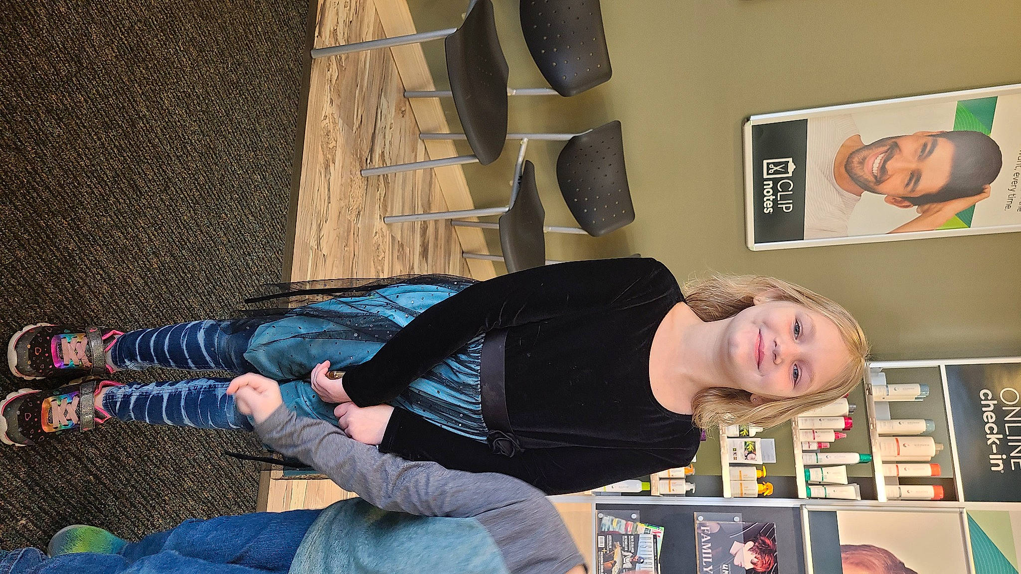 Layla joined the competition — help win amazing prizes! audio_equipment, comfort, denim, elbow, eyewear, flooring, fun, human_leg, joint, joy, knee, pattern, person, picture_frame, room, shelf, sitting, t_shirt, thigh, wrist