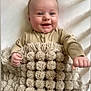 Rogan joined the competition — help win amazing prizes! baby, bed, blanket, child, comfort, cozy, cute, face, hand, happy, infant, lying_down, onesie, pom_pom, portrait, skin, smiling, soft, texture, warm