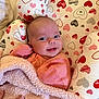 Layla joined the competition — help win amazing prizes! baby, blanket, child, closeup, comfort, cozy, cushion, cute, face, happy, heart_pattern, indoor, infant, newborn, person, pink_clothing, portrait, resting, smile, soft_texture