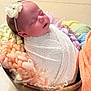 baby, blanket, child, colorful, cozy, cute, flower, headband, indoors, infant, knit, newborn, peaceful, portrait, resting, sleeping, soft, wooden_bowl, wrapped, yarn