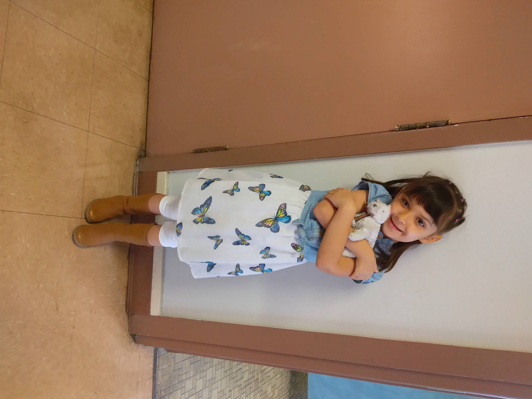 Alyssa joined the competition — help win amazing prizes! baby_toddler_clothing, child, comfort, elbow, floor, flooring, foot, hardwood, human_leg, joy, knee, pattern, person, room, sandal, sitting, sleeve, sock, thigh, toddler