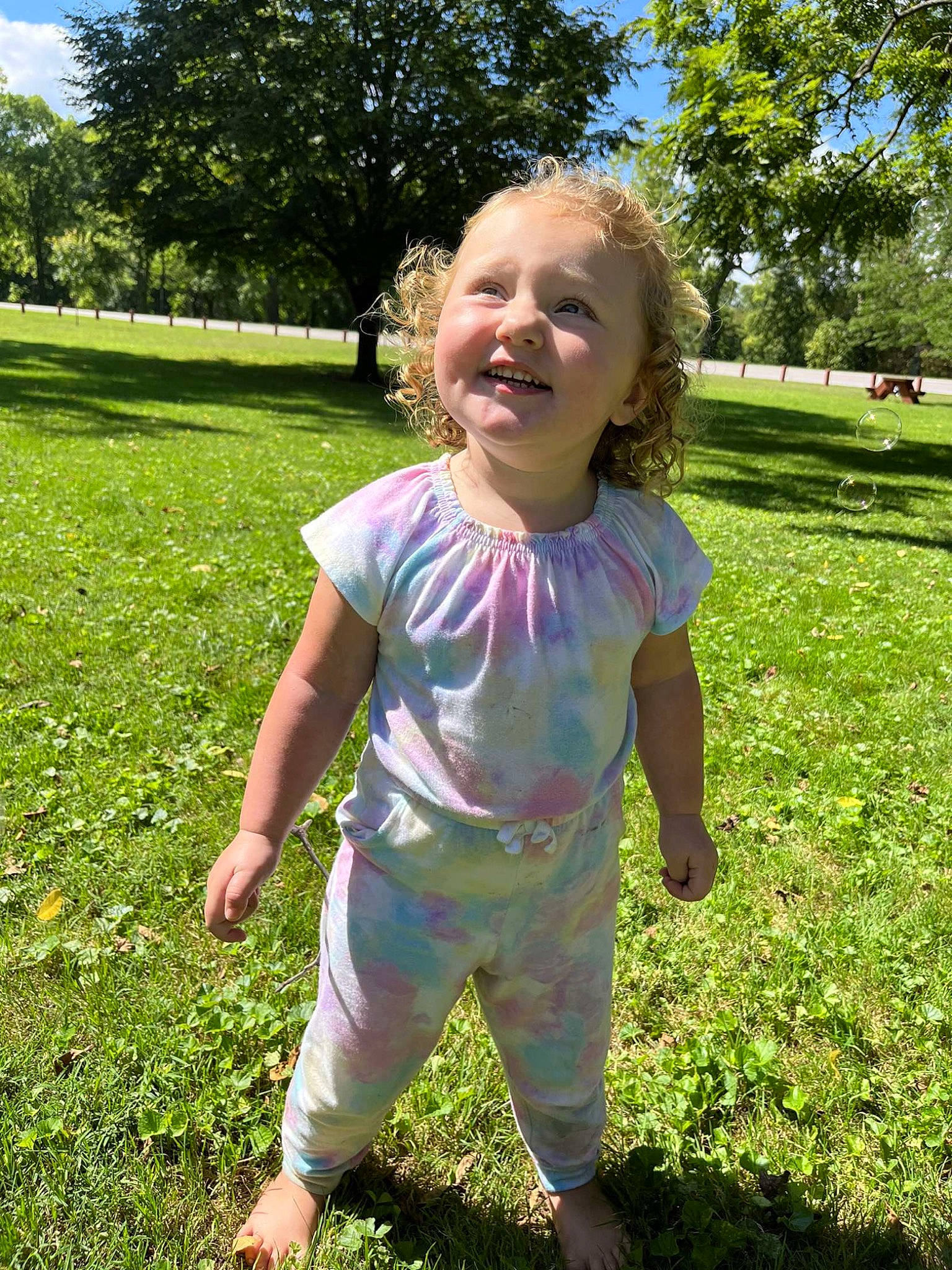 Fiona is registered to the contest to win money with this photo: baby_toddler_clothing, fun, grass, grass_family, grassland, green, groundcover, happy, leaf, meadow, people_in_nature, person, pink, plant, sky, sleeve, smile, summer, terrestrial_plant, toddler
