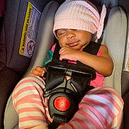 Nakiea is registered to the contest to win money with this photo: baby, sleeping, car_seat, pink_hat, striped_pants, socks, infant, child, resting, seatbelt, safety, cute, adorable, newborn, peaceful, indoors, closeup, young_child, baby_clothes, transport