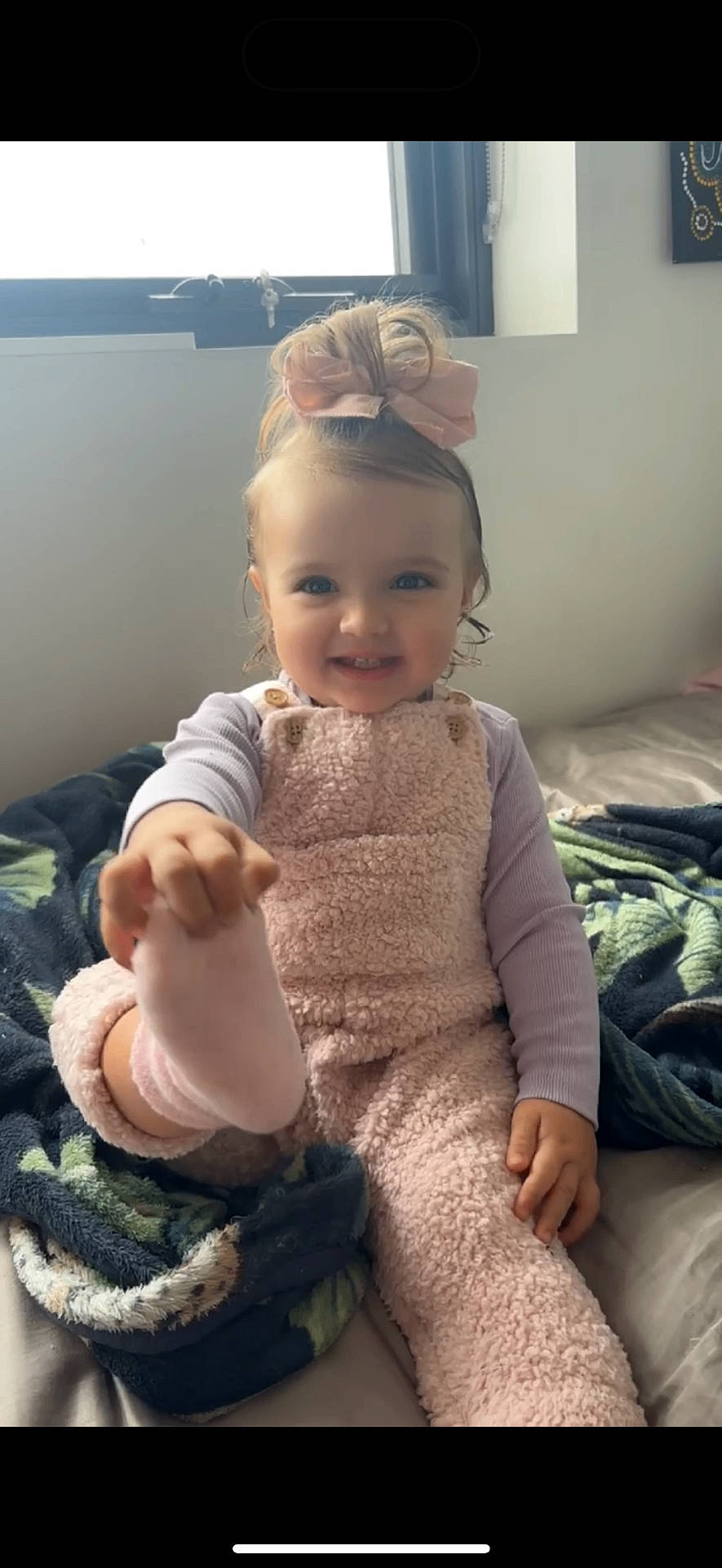 Saige is registered to the contest to win money with this photo: baby, bodypart, clothing, couch, cushion, dress, face, finger, furniture, hand, happy, head, homedecor, indoors, interiordesign, person, photography, portrait, sitting, smile