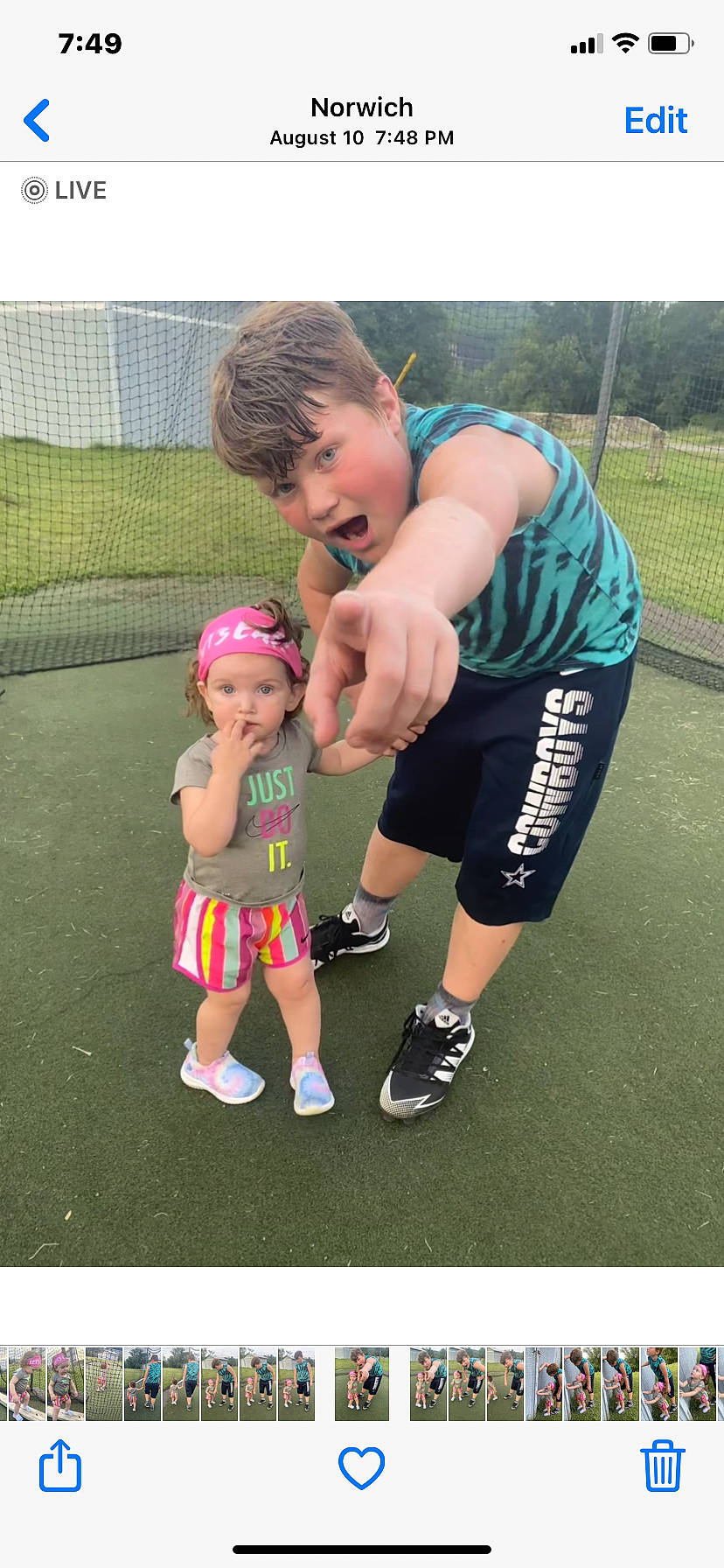 Thea Bean is registered to the contest to win money with this photo: baby, baby_products, baby_toddler_clothing, child, eyewear, fun, gesture, grass, happy, headwear, leisure, person, personal_protective_equipment, play, recreation, sandal, shoe, shorts, sneakers, surprise