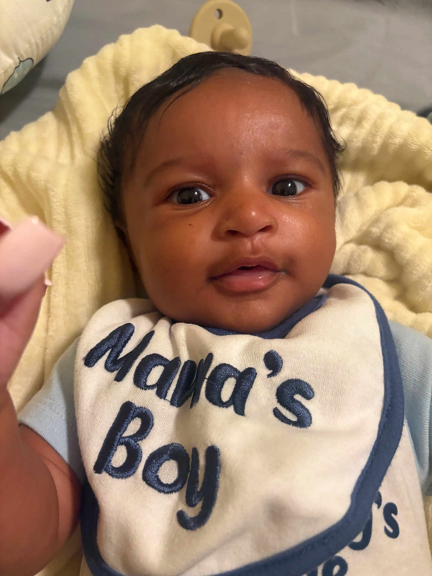 Armani is registered to the contest to win money with this photo: baby, infant, face, bib, clothing, blanket, smile, cute, child, young, skin, portrait, head, eyes, mouth, person, soft, fabric, indoor, closeup