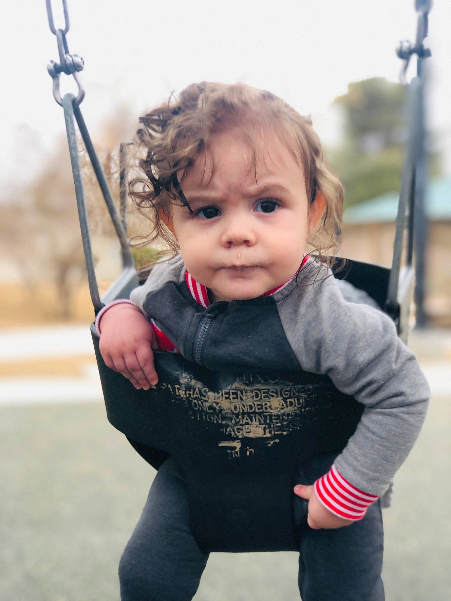 Atlas is registered to the contest to win money with this photo: baby, baby_toddler_clothing, blond, cheek, child, city, electric_blue, face, fun, grass, happy, leisure, person, playground, recreation, skin, sky, sleeve, swing, t_shirt