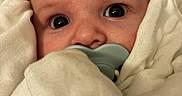 George joined the competition — help win amazing prizes! baby, pacifier, blanket, closeup, face, infant, wrapped, soft, cute, child, newborn, skin, eyes, expression, warm, comfort, hooded, portrait, young, indoors