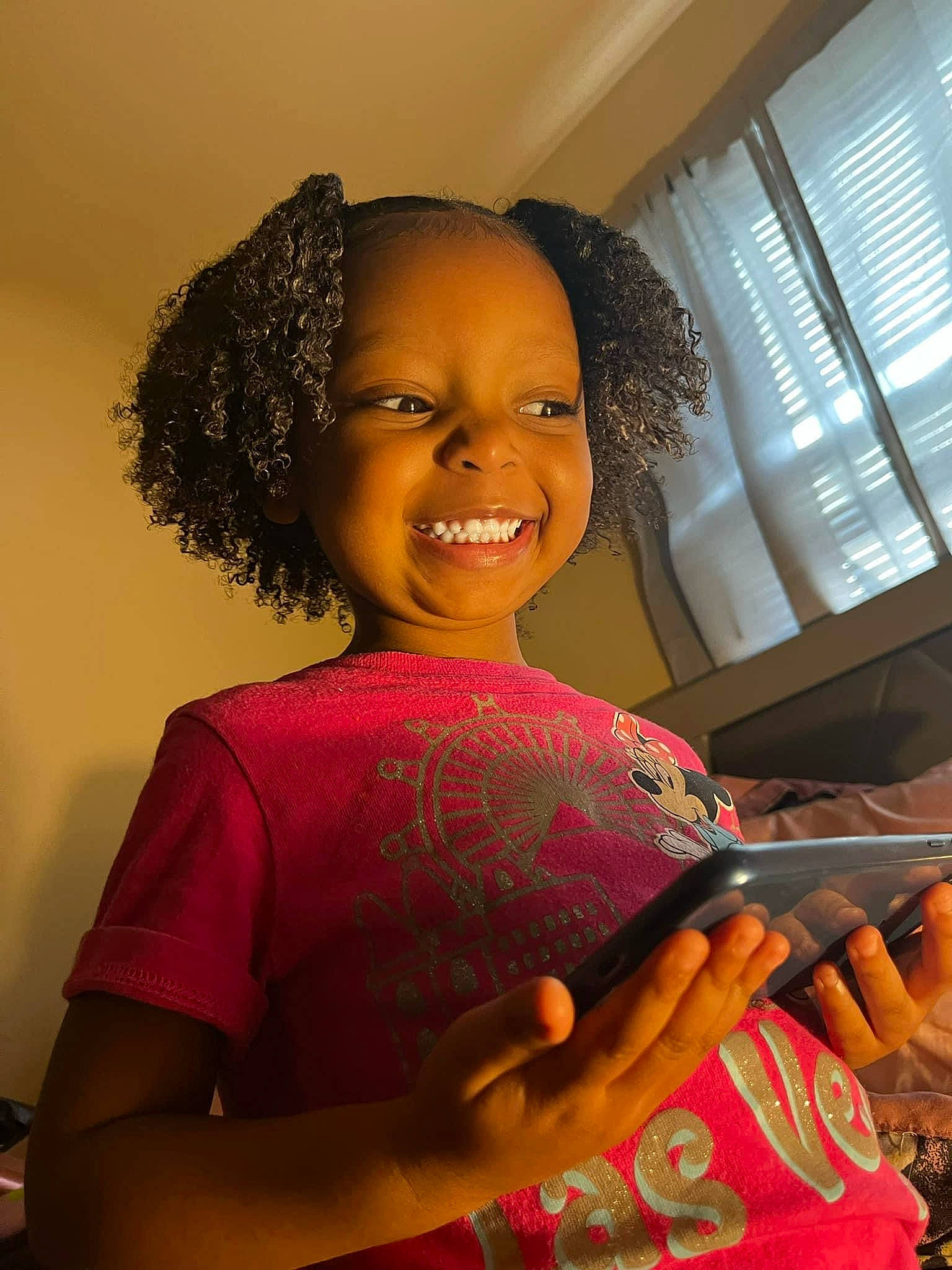 Nalayah is registered to the contest to win money with this photo: afro, audio_equipment, black_hair, cheek, child, facial_expression, fun, hand, happy, jewellery, jheri_curl, joy, magenta, person, room, sitting, skin, smile, standing, thumb
