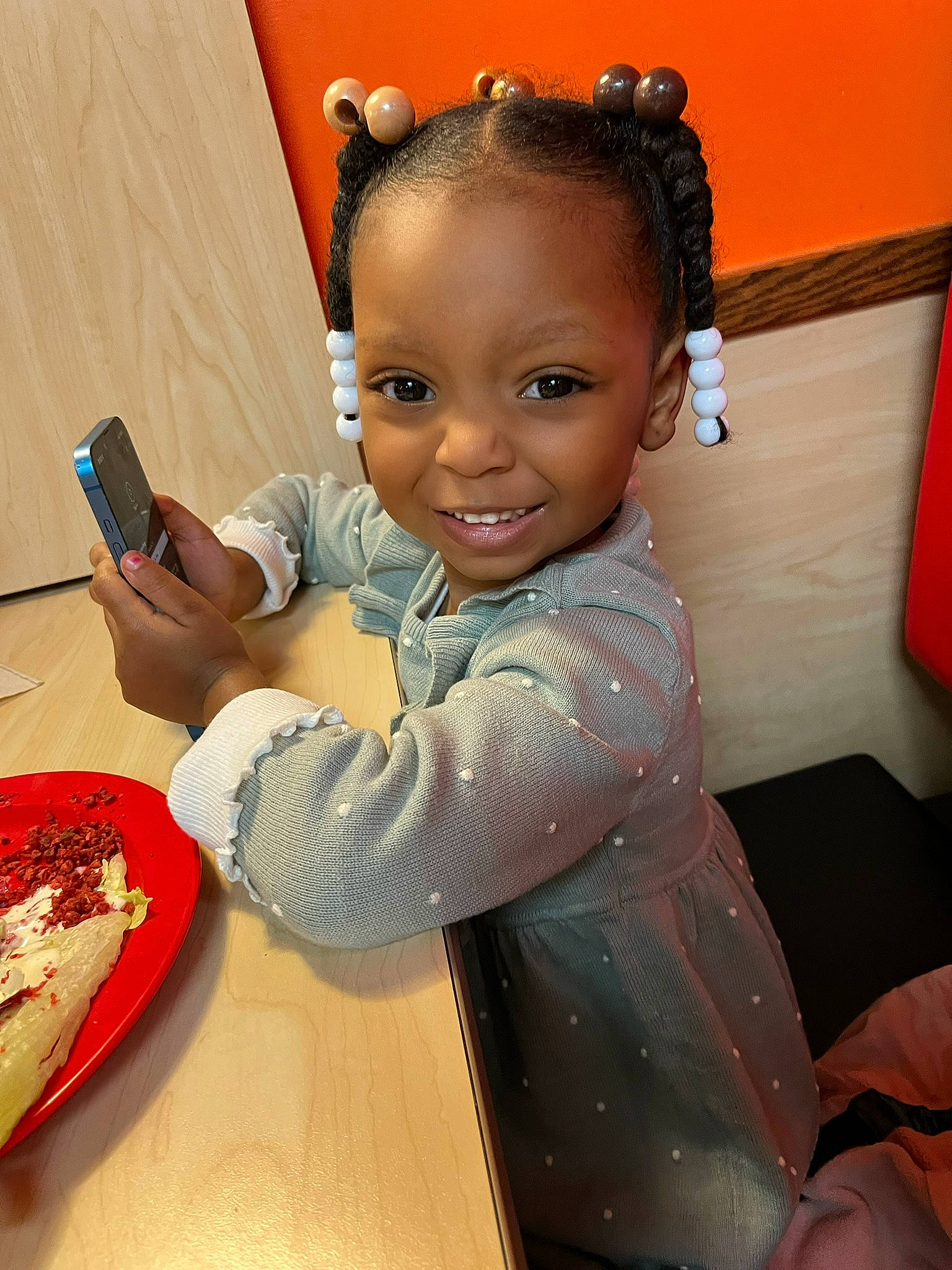 Nalayah is registered to the contest to win money with this photo: baby, baby_toddler_clothing, bowl, child, comfort_food, cuisine, dish, finger, food, fun, hairstyle, happy, joy, mobile_phone, person, plate, sleeve, smile, table, tableware