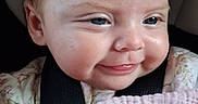 Maleia joined the competition — help win amazing prizes! baby, infant, child, portrait, smiling, happy, face, eyes, hair, blanket, pink_blanket, floral_clothing, car_seat, harness, close_up, indoors, seated, photography, cute, head