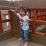 Anna Isabella a rejoint le concours — aidez-le/la à gagner de superbes lots ! child, toddler, girl, clothing, tshirt, jeans, sneakers, headband, outdoor, concrete, railing, building, window, happy, smiling, person, standing, playful, balcony, daylight
