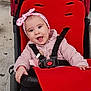 baby, child, stroller, red, black, headband, pink, smiling, happy, infant, outdoor, seatbelt, jacket, cute, person, portrait, baby_girl, clothing, sitting, joyful