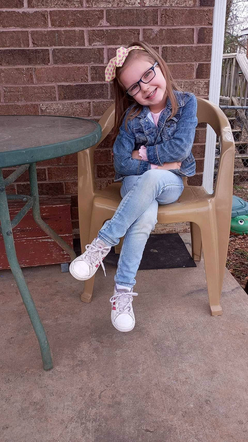 Sarah is registered to the contest to win money with this photo: brown_hair, denim, electric_blue, eye, eyewear, face, fawn, flooring, fun, furniture, happy, hardwood, human_leg, jeans, joy, knee, leisure, pattern, person, thigh