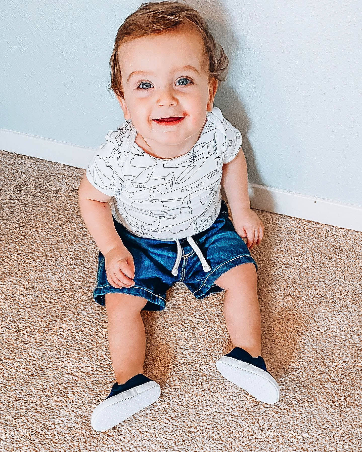 Franklin is registered to the contest to win money with this photo: baby, baby_toddler_clothing, blue, child, child_model, dress, flooring, footwear, fun, head, joy, leg, pattern, person, play, shoe, sitting, skin, smile, standing