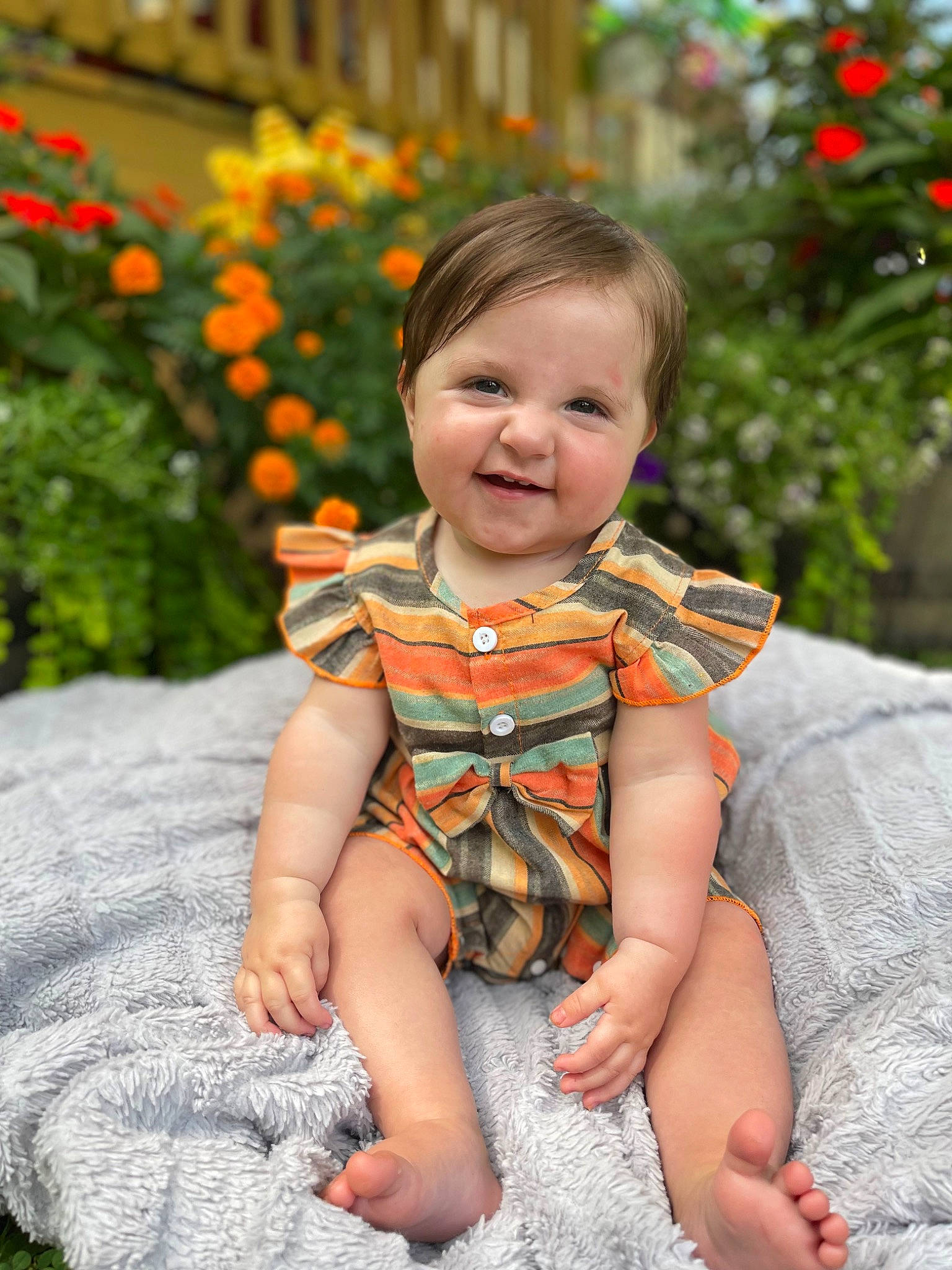 Alayna is registered to the contest to win money with this photo: baby_toddler_clothing, dress, eye, face, facial_expression, flower, grass, hairstyle, happy, head, iris, jeans, joy, leaf, orange, person, photograph, plant, skin, sleeve