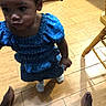 Callieann joined the competition — help win amazing prizes! child, toddler, girl, blue_dress, dress, polka_dots, standing, indoors, wood_floor, tile_floor, chair, furniture, feet, portrait, close_up, curly_hair, dark_skin, serious_expression, home, photography
