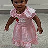 baby, child, toddler, portrait, standing, smiling, pink_dress, hair_bow, bow, shoes, indoor, tile_floor, brick_wall, full_body, fashion, cute, person, face, photography, happy