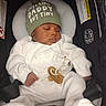 Noah is registered to the contest to win money with this photo: baby, sleeping, infant, hat, pacifier, car_seat, white_clothing, green_hat, child, cute, peaceful, indoors, seatbelt, newborn, soft_texture, knitwear, resting, small_hands, adorable, baby_accessory