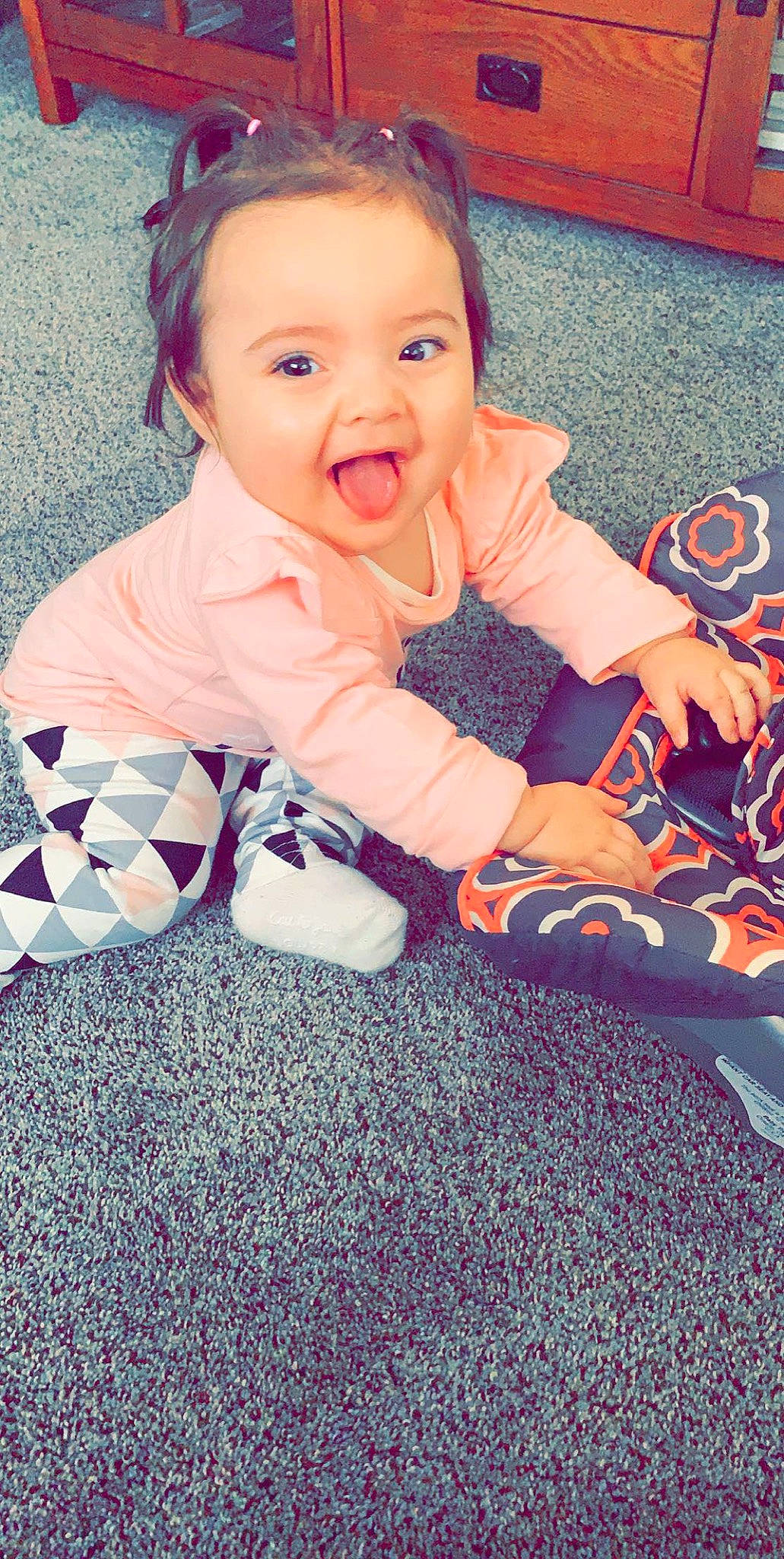 Kinlee is registered to the contest to win money with this photo: baby, baby_toddler_clothing, beauty, cheek, child, eye, face, facial_expression, flooring, head, leg, pattern, person, pink, play, sitting, skin, smile, textile, toddler