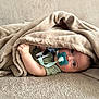 baby, blanket, pacifier, infant, cozy, cute, child, soft_texture, bed, resting, wrapped, hand, face, lying_down, comfort, indoor, young_child, skin, expression, clothing