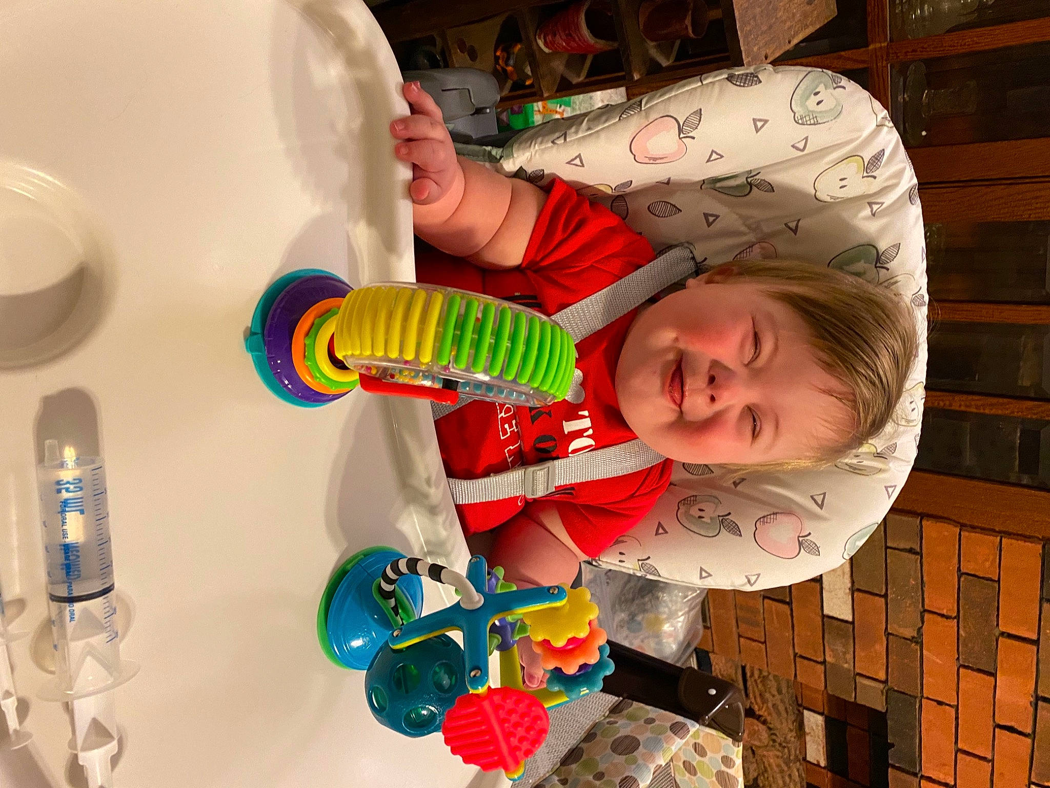 Justin Jr. is registered to the contest to win money with this photo: baby_toddler_clothing, bottle, bottled_water, child, drinkware, fluid, fun, happy, leisure, liquid, party_supply, person, plastic, plastic_bottle, play, product, smile, toddler, toy, water