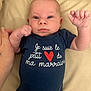 Louis participe au concours pour gagner de l'argent avec cette photo : baby, infant, face, hand, clothing, onesie, blue, heart, text, cushion, beige, person, skin, newborn, lying, cute, portrait, expression, human, child