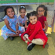 Anabia joined the competition — help win amazing prizes! child, children, girl, smiling, playground, outdoor, happy, sitting, dress, casual_clothing, glasses, pigtails, sunny_day, play, friends, group, young, fun, colorful_clothes, grass