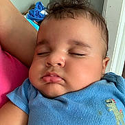 Yassiel Torres joined the competition — help win amazing prizes! arm, baby, blue_onesie, child, closeup, clothing, curly_hair, cute, dinosaur_patch, doorframe, face, indoor, infant, napping, peaceful, person, pink_shirt, resting, skin, sleeping