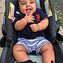 baby, child, cute, face, footwear, grass, hand, happy, infant, outdoor, person, polo_shirt, sandals, seat, shorts, sidewalk, skin, smiling, stroller, summer