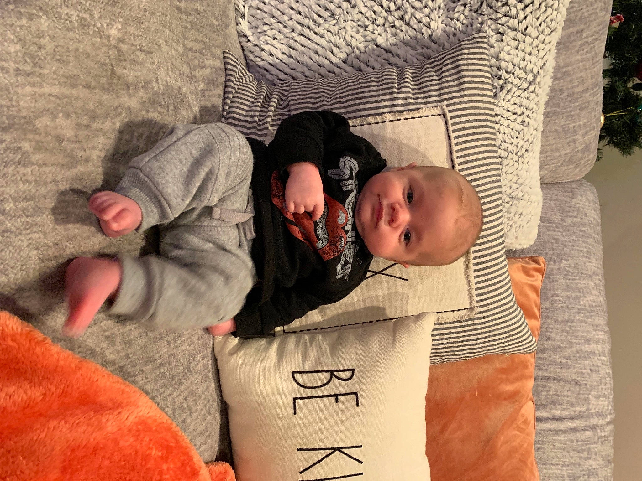 Cade is registered to the contest to win money with this photo: baby, baby_products, baby_toddler_clothing, child, comfort, flooring, fun, grass, hat, human, linens, nap, person, room, sitting, smile, textile, toddler, tree, vacation