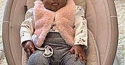 Ayla Makoni is registered to the contest to win money with this photo: baby, infant, pink_bow, baby_rocker, cushion, fluffy_vest, gray_pants, white_socks, pacifier, carpet, indoor, cute, child, headband, portrait, relaxed, seated, soft_lighting, cozy, comfortable