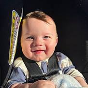 Azran joined the competition — help win amazing prizes! baby, smiling, car_seat, child, blanket, sunlight, happy, infant, face, clothing, seatbelt, cute, portrait, hand, young_child, skin, indoor, seat, person, closeup