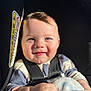 baby, smiling, car_seat, child, blanket, sunlight, happy, infant, face, clothing, seatbelt, cute, portrait, hand, young_child, skin, indoor, seat, person, closeup