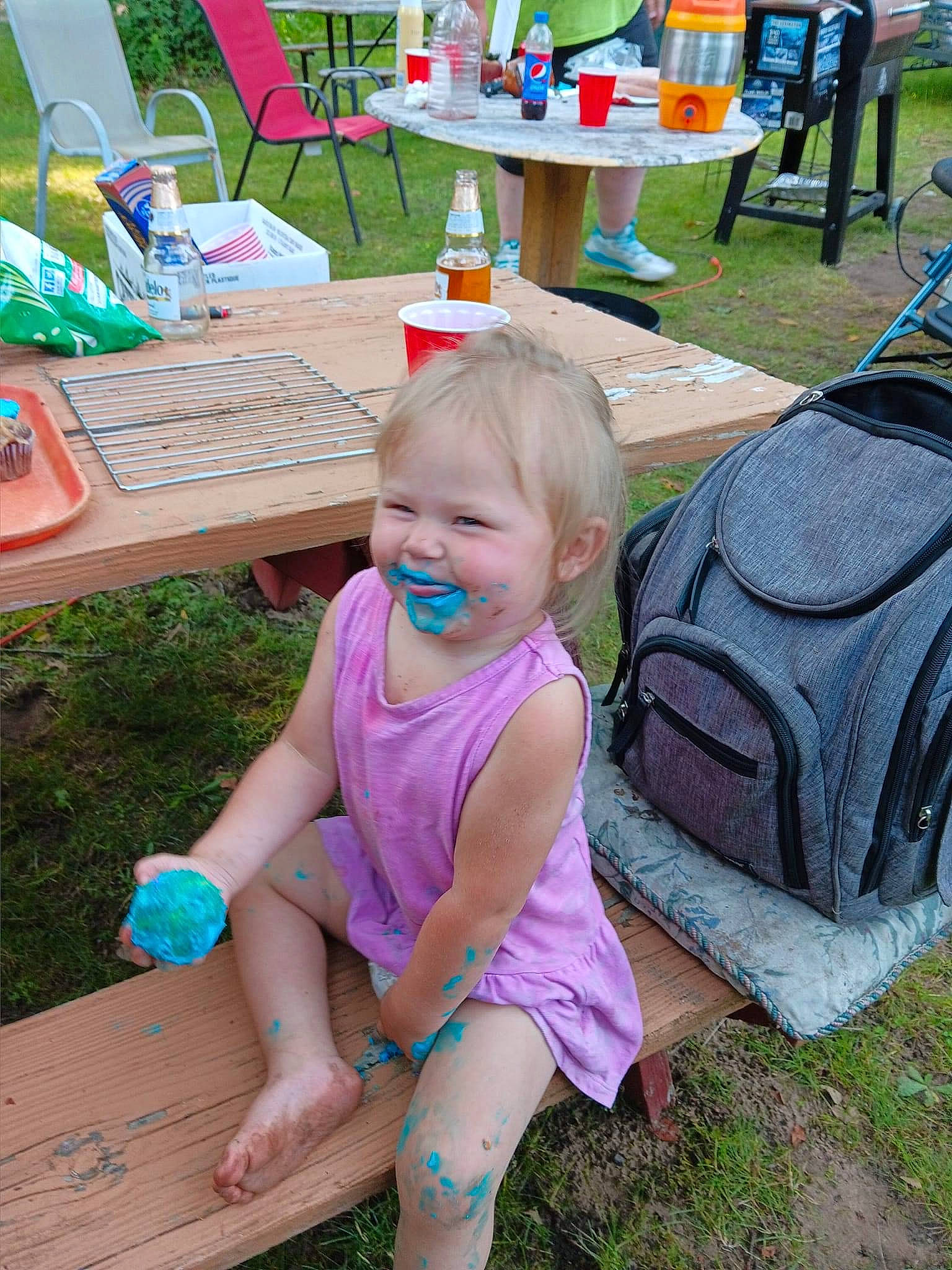 Posie joined the competition — help win amazing prizes! baby_toddler_clothing, bench, chair, child, fun, garden, grass, green, joy, leisure, outdoor_furniture, outdoor_table, person, public_space, recreation, sitting, smile, summer, table, thigh