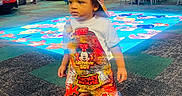 Kairo joined the competition — help win amazing prizes! toddler, child, boy, clothing, mickey_mouse, overalls, cap, shoes, indoor, arcade, play_area, carpet, people, family, game_machine, colorful, floor, standing, portrait, entertainment_center